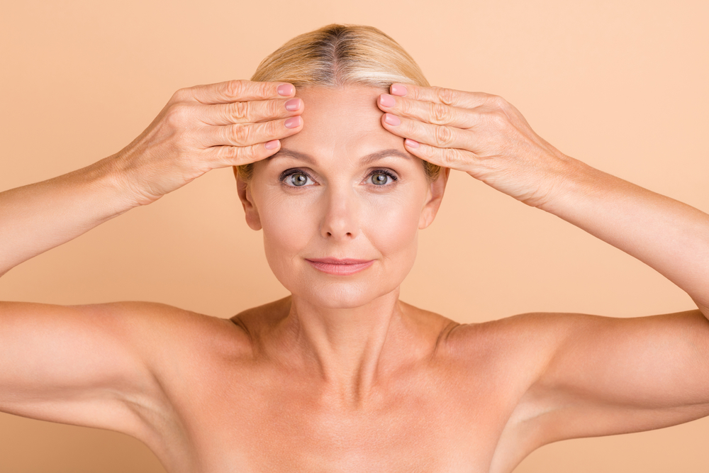 A woman looking at the results of a forehead lift in Raleigh